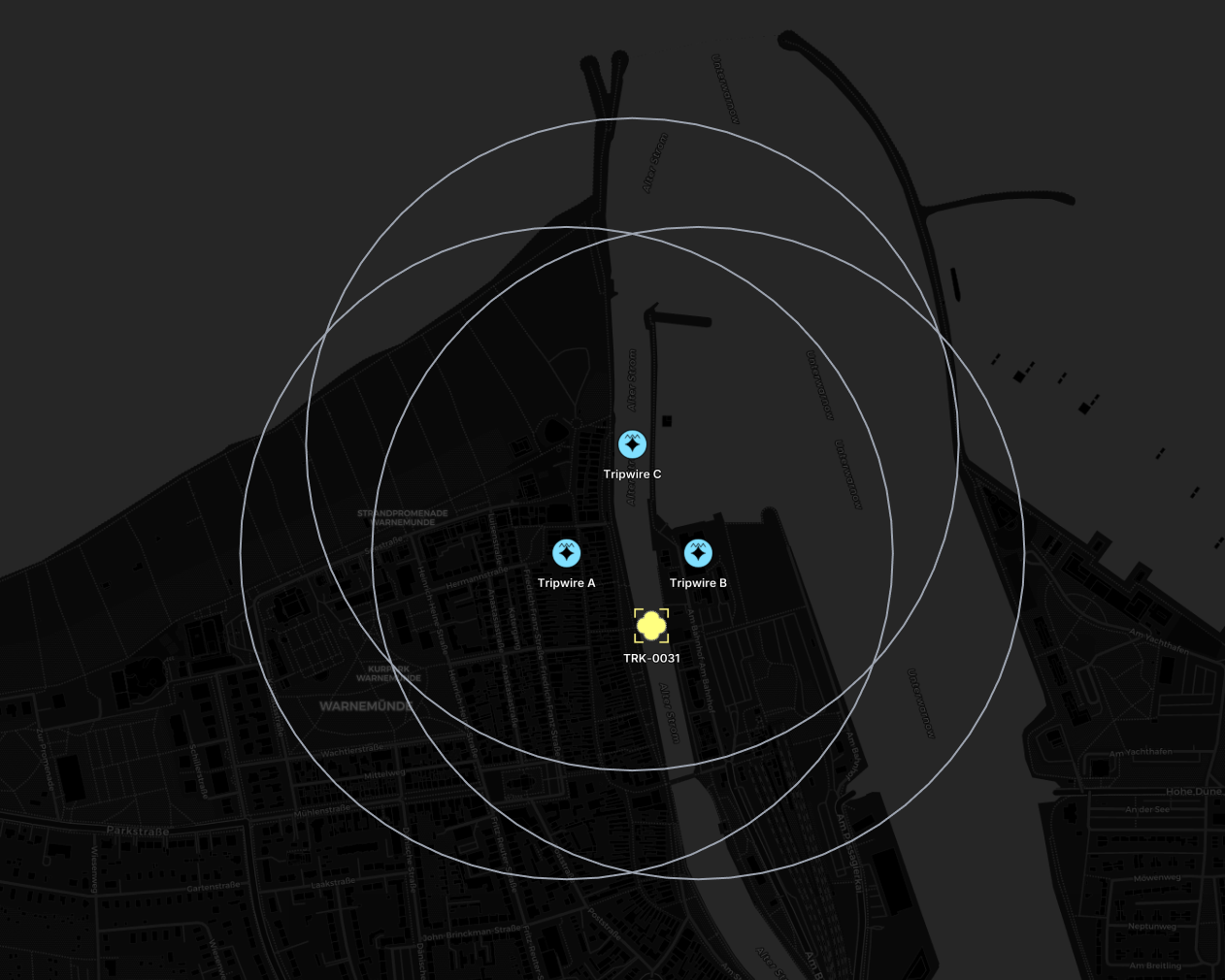 Three tripwire sensors with range rings that cross at the solved track position south of them